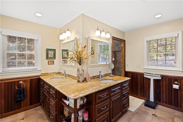 10 Bartlett Rd, Middletown, RI 02842 - full bathroom with double vanity, a wainscoted wall, and tile patterned floors