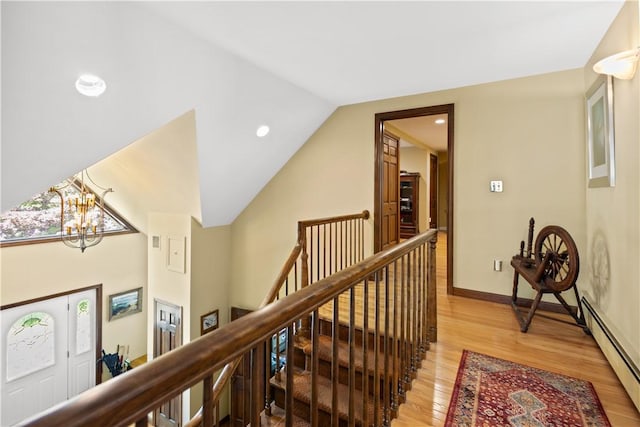 10 Bartlett Rd, Middletown, RI 02842 - hallway featuring an upstairs landing, a baseboard radiator, light wood finished floors, a chandelier, and vaulted ceiling