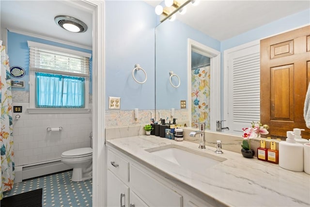 10 Bartlett Rd, Middletown, RI 02842 - full bathroom with a baseboard radiator, vanity, toilet, tile walls, and a wainscoted wall