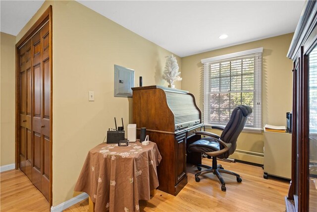 10 Bartlett Rd, Middletown, RI 02842 - office area featuring light wood-style floors, electric panel, recessed lighting, baseboards, and a baseboard radiator