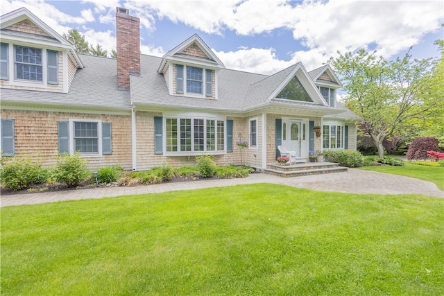 10 Bartlett Rd, Middletown, RI 02842 - view of front of home featuring a chimney, roof with shingles, and a front yard