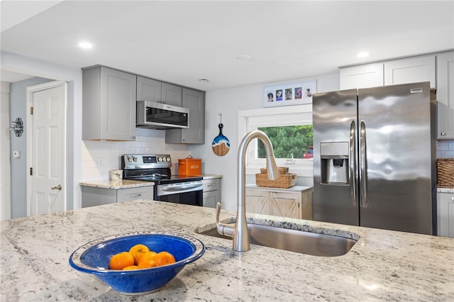 250 Shippee Plat Rd, Coventry, RI 02816 - kitchen with stainless steel appliances, a sink, gray cabinets, light stone counters, and tasteful backsplash