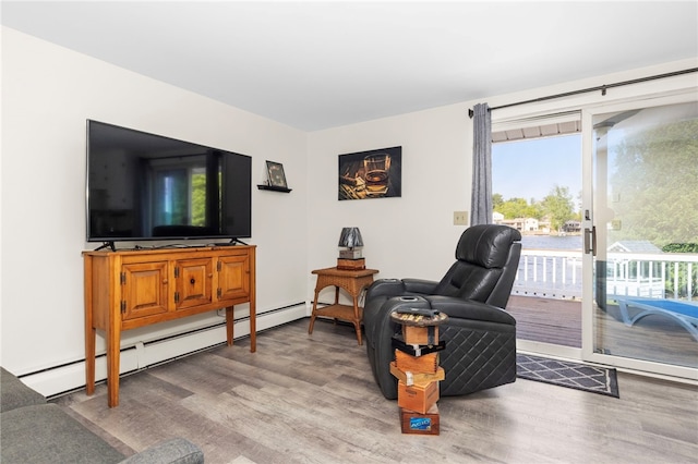 250 Shippee Plat Rd, Coventry, RI 02816 - living room with a baseboard heating unit and wood finished floors