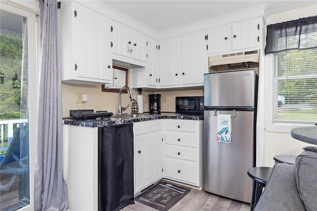 250 Shippee Plat Rd, Coventry, RI 02816 - kitchen featuring freestanding refrigerator, black microwave, dark countertops, white cabinets, and a sink