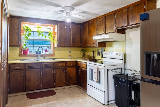71 Julian St, Pawtucket, RI 02861 - kitchen with white range with electric stovetop, a sink, stainless steel refrigerator with ice dispenser, under cabinet range hood, and light countertops