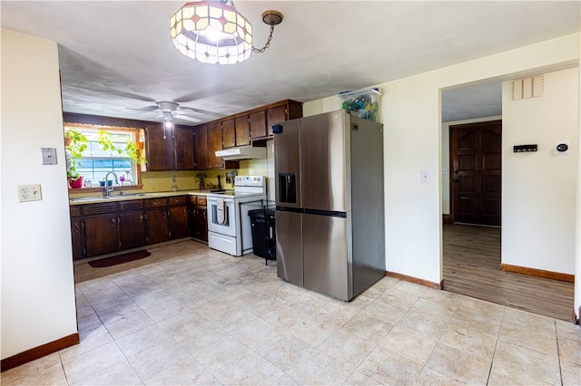 71 Julian St, Pawtucket, RI 02861 - kitchen featuring stainless steel refrigerator with ice dispenser, electric range, light countertops, under cabinet range hood, and a sink
