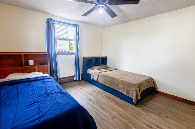 71 Julian St, Pawtucket, RI 02861 - bedroom featuring a baseboard heating unit, wood finished floors, and a ceiling fan