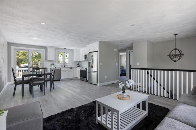 99 Scranton Ave, Warwick, RI 02888 - living area featuring light wood-style flooring, baseboards, and recessed lighting