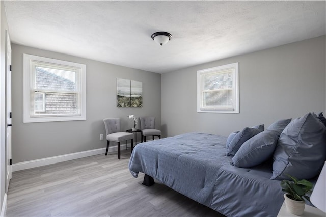 99 Scranton Ave, Warwick, RI 02888 - bedroom with multiple windows, light wood-style flooring, and baseboards