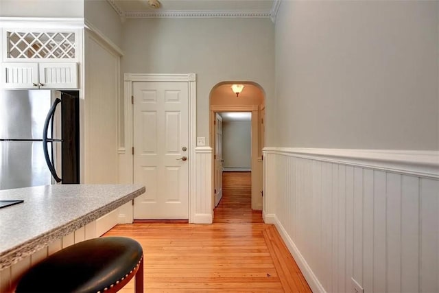 368 Thayer St Unit 2, Providence, RI 02906 - hall with arched walkways, ornamental molding, light wood finished floors, wainscoting, and a baseboard radiator