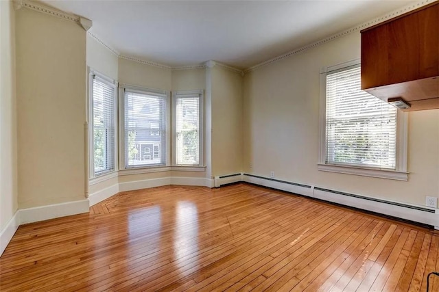 368 Thayer St Unit 2, Providence, RI 02906 - empty room with light wood-type flooring, a baseboard heating unit, baseboards, and ornamental molding