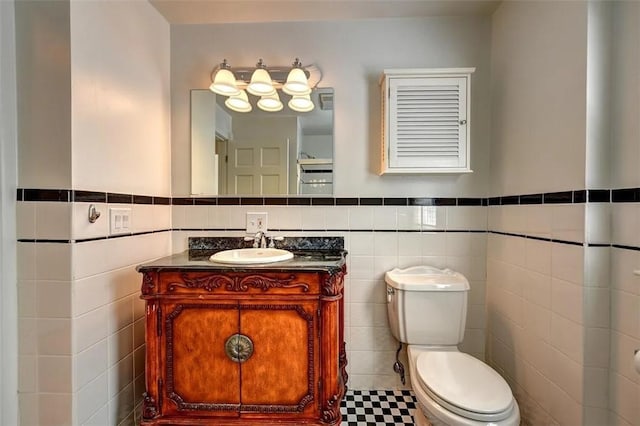 368 Thayer St Unit 2, Providence, RI 02906 - half bath featuring tile walls, toilet, a wainscoted wall, and vanity