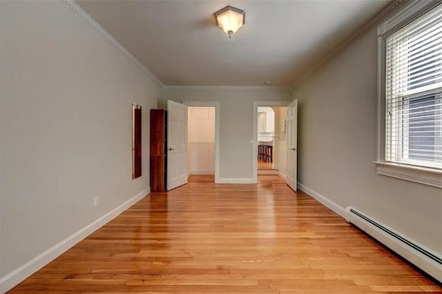368 Thayer St Unit 2, Providence, RI 02906 - unfurnished bedroom featuring a baseboard radiator, light wood finished floors, crown molding, baseboards, and a spacious closet