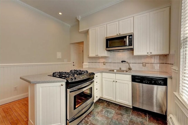 368 Thayer St Unit 2, Providence, RI 02906 - kitchen with appliances with stainless steel finishes, a sink, a baseboard radiator, tasteful backsplash, and light countertops