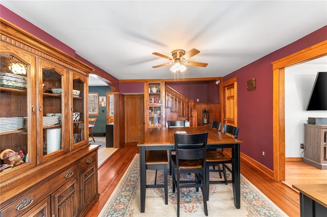 34 Bates Ave, Coventry, RI 02816 - dining area with light wood-type flooring, a ceiling fan, arched walkways, and baseboards