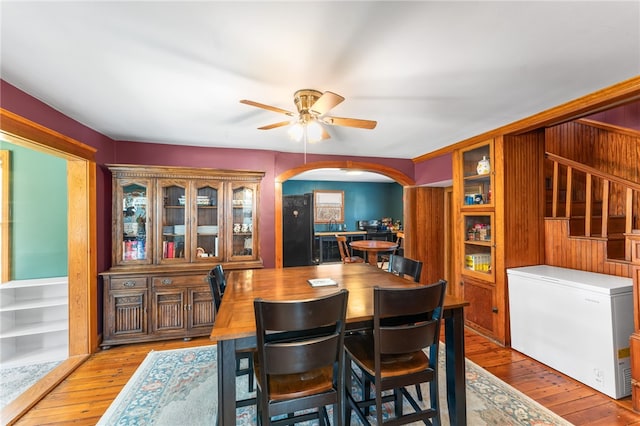 34 Bates Ave, Coventry, RI 02816 - dining room with arched walkways, light wood-style flooring, and a ceiling fan