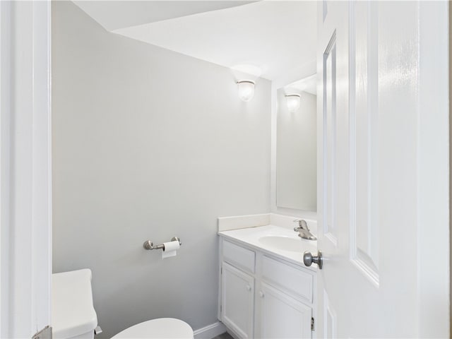626 Smithfield Rd Unit 909, North Providence, RI 02904 - half bathroom featuring toilet, vanity, and baseboards