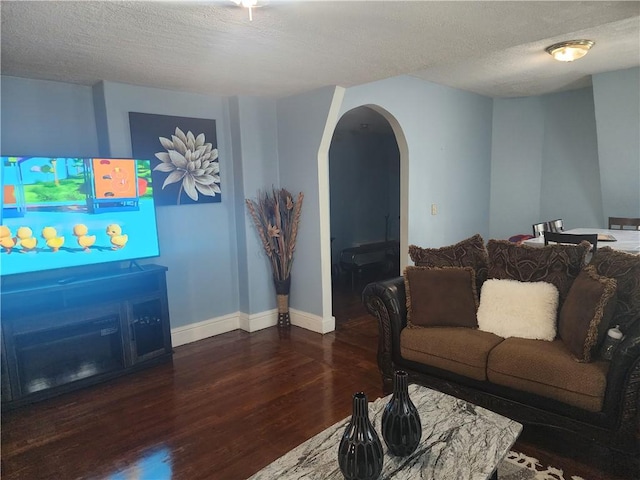 95 Congress Ave, Providence, RI 02907 - living area featuring wood finished floors, arched walkways, a textured ceiling, and baseboards