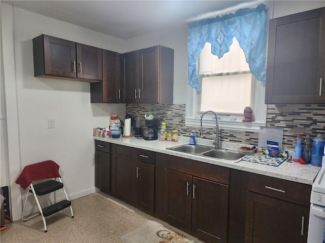 95 Congress Ave, Providence, RI 02907 - kitchen with a sink, backsplash, light countertops, baseboards, and dark brown cabinetry