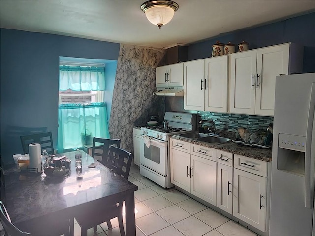 95 Congress Ave, Providence, RI 02907 - kitchen featuring white appliances, under cabinet range hood, a sink, dark countertops, and light tile patterned floors