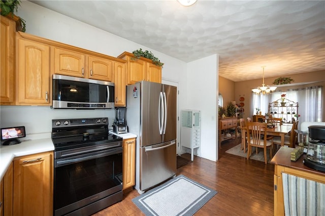 21 Fieldstone Dr, Coventry, RI 02816 - kitchen featuring appliances with stainless steel finishes, a chandelier, light countertops, and dark wood finished floors