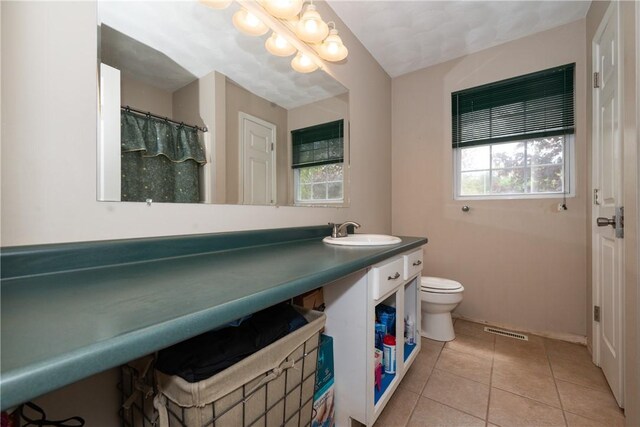 21 Fieldstone Dr, Coventry, RI 02816 - full bathroom with tile patterned flooring, toilet, vanity, and a chandelier