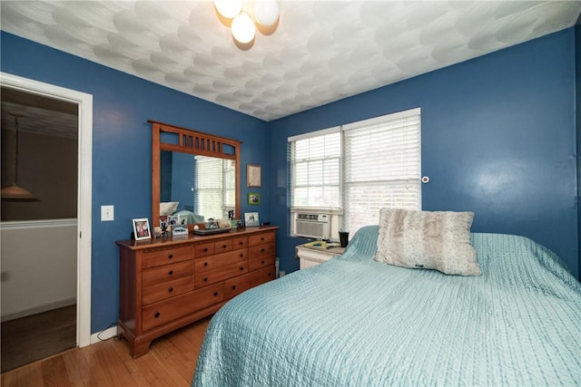 21 Fieldstone Dr, Coventry, RI 02816 - bedroom with wood finished floors, cooling unit, and baseboards