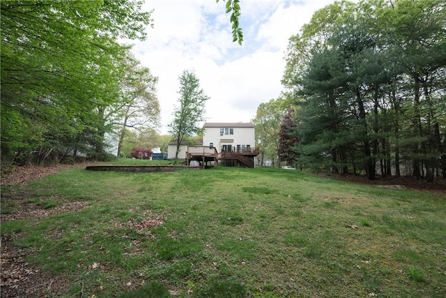 21 Fieldstone Dr, Coventry, RI 02816 - view of green lawn with stairway and a wooden deck