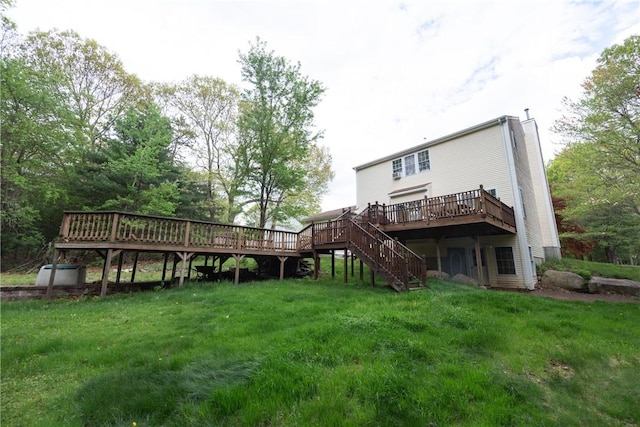 21 Fieldstone Dr, Coventry, RI 02816 - back of property with a wooden deck, stairs, and a yard