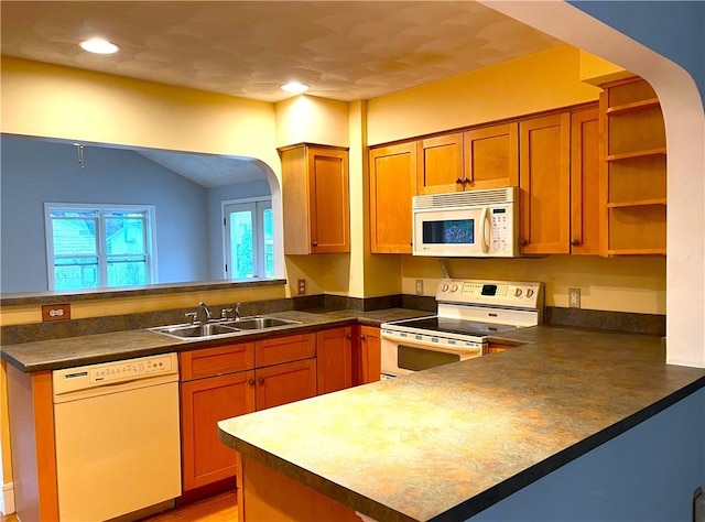 10 Cavalier Rd, Narragansett, RI 02882 - kitchen with white appliances, a peninsula, a sink, arched walkways, and lofted ceiling