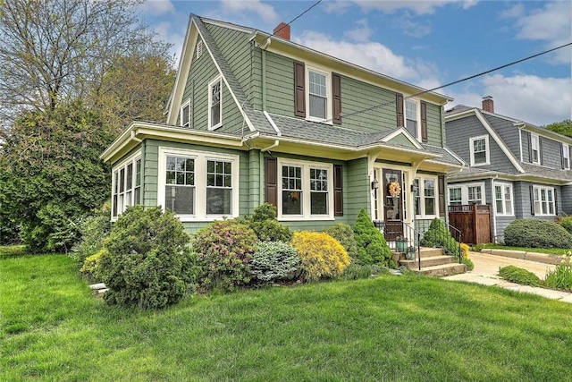 77 Glen Ave, Cranston, RI 02905 - view of front of house featuring a front yard and a chimney