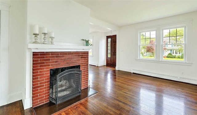 77 Glen Ave, Cranston, RI 02905 - unfurnished living room with a brick fireplace, wood finished floors, a baseboard heating unit, and baseboards