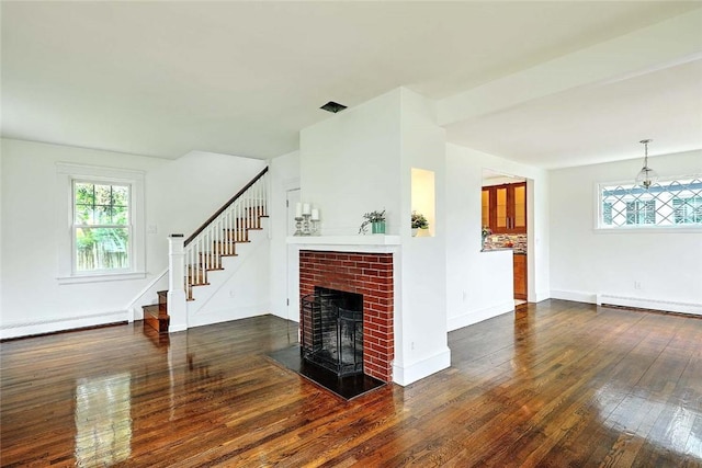 77 Glen Ave, Cranston, RI 02905 - unfurnished living room featuring wood-type flooring, plenty of natural light, a brick fireplace, and stairway