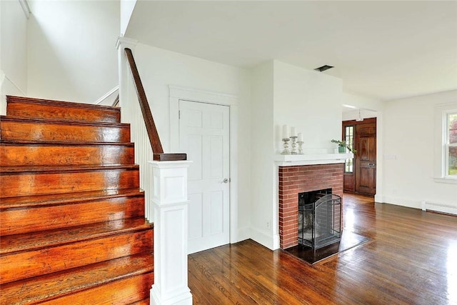 77 Glen Ave, Cranston, RI 02905 - stairway featuring wood finished floors, baseboards, a fireplace, and a baseboard heating unit