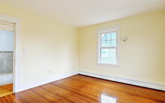 77 Glen Ave, Cranston, RI 02905 - spare room featuring wood-type flooring, a baseboard heating unit, and baseboards