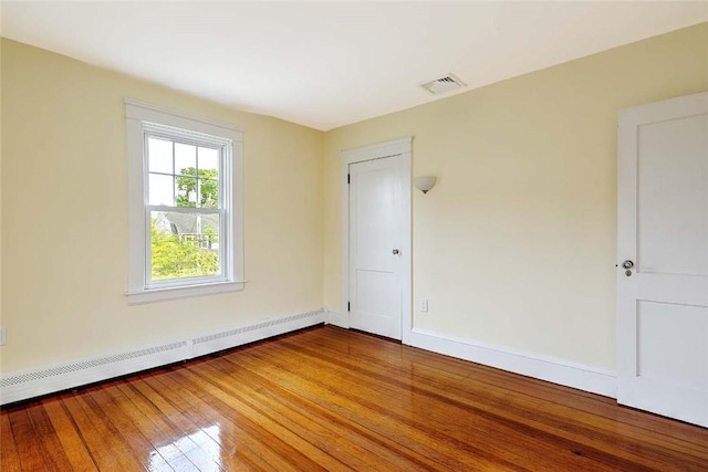 77 Glen Ave, Cranston, RI 02905 - spare room with a baseboard radiator, hardwood / wood-style flooring, and baseboards