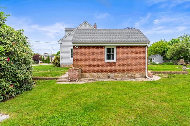 12 Arlington St, Westerly, RI 02891 - rear view of property with a lawn, a chimney, a shingled roof, and brick siding