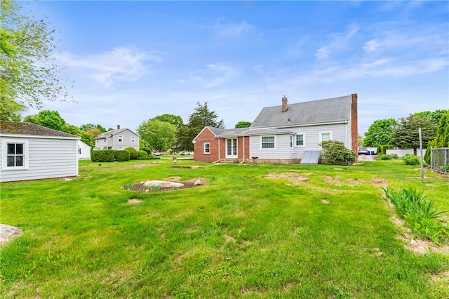 12 Arlington St, Westerly, RI 02891 - back of property featuring a lawn, a chimney, and entry steps