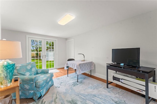 12 Arlington St, Westerly, RI 02891 - living area with french doors, wood finished floors, and baseboards