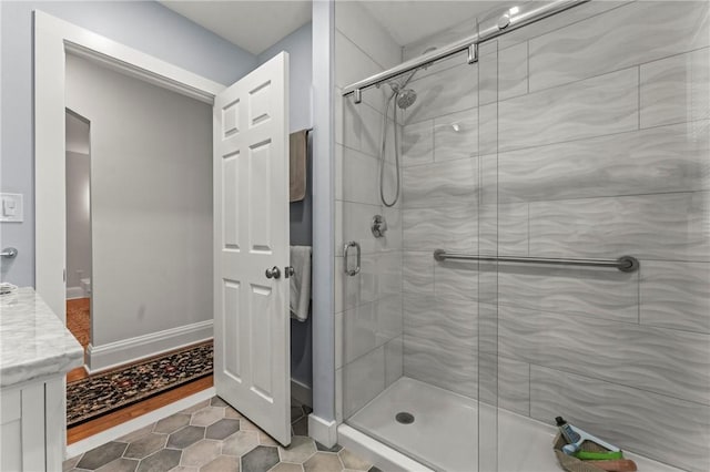 12 Arlington St, Westerly, RI 02891 - full bathroom with a stall shower, tile patterned floors, vanity, and baseboards