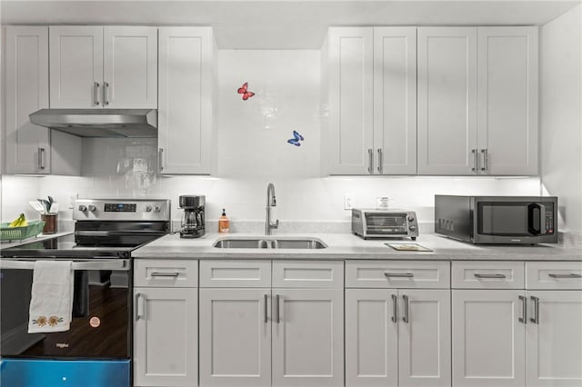 12 Arlington St, Westerly, RI 02891 - kitchen with stainless steel appliances, a sink, under cabinet range hood, and white cabinets