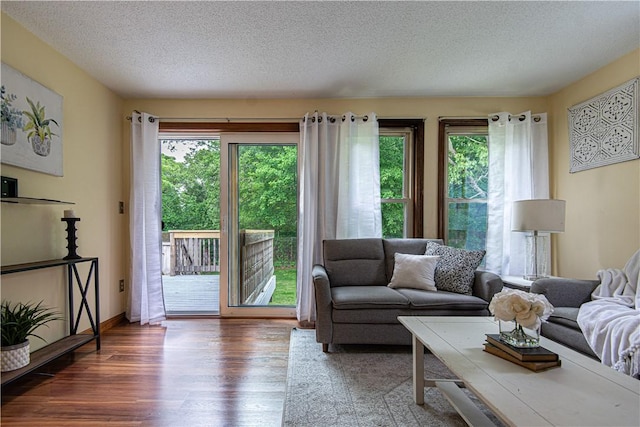 417 Privilege St, Woonsocket, RI 02895 - living room featuring wood finished floors, healthy amount of natural light, and a textured ceiling