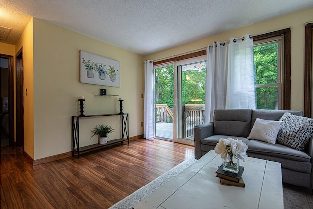 417 Privilege St, Woonsocket, RI 02895 - living area with dark wood-style flooring, a textured ceiling, and baseboards