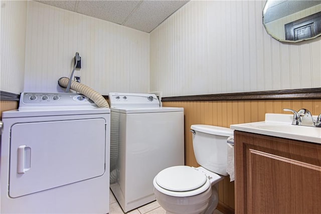 417 Privilege St, Woonsocket, RI 02895 - bathroom featuring independent washer and dryer, toilet, vanity, tile patterned flooring, and wallpapered walls