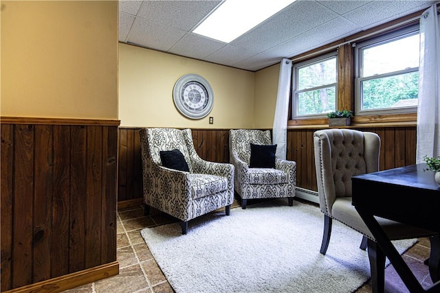417 Privilege St, Woonsocket, RI 02895 - home office with wainscoting, a drop ceiling, wood walls, and a baseboard heating unit