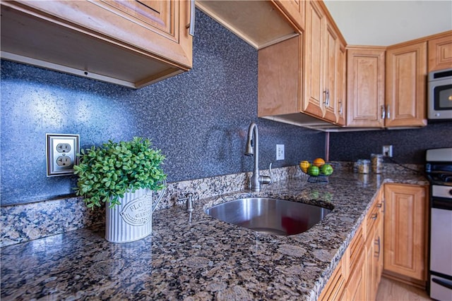 417 Privilege St, Woonsocket, RI 02895 - kitchen featuring a sink, stainless steel appliances, dark stone counters, and tasteful backsplash