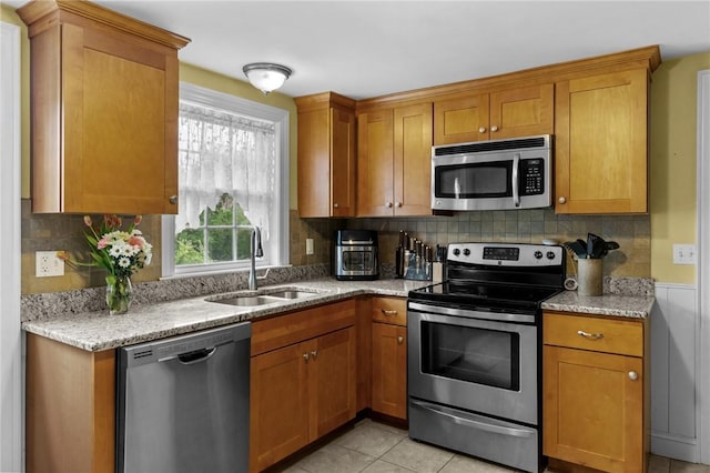 223 Chopmist Hill Rd, Glocester, RI 02814 - kitchen with appliances with stainless steel finishes, a sink, light stone counters, and brown cabinets