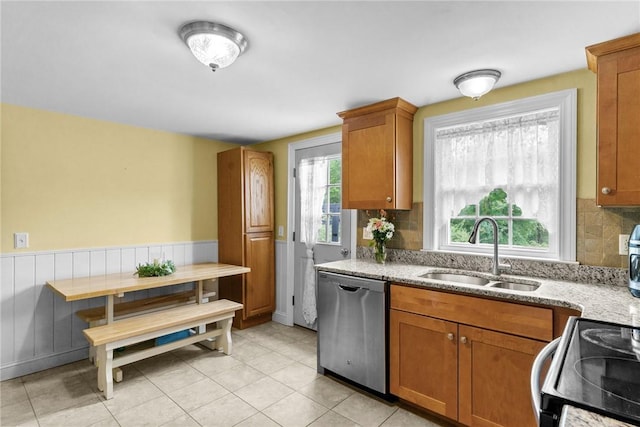 223 Chopmist Hill Rd, Glocester, RI 02814 - kitchen with a sink, stainless steel dishwasher, black range with electric cooktop, brown cabinetry, and wainscoting