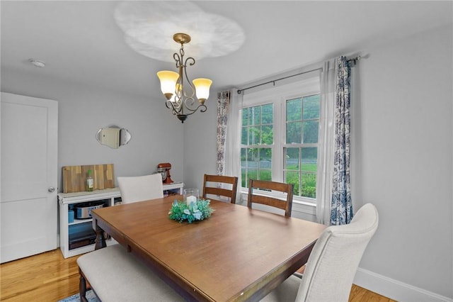 223 Chopmist Hill Rd, Glocester, RI 02814 - dining space with a chandelier, light wood-type flooring, and baseboards