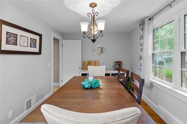223 Chopmist Hill Rd, Glocester, RI 02814 - dining space featuring healthy amount of natural light, a chandelier, wood finished floors, and baseboards